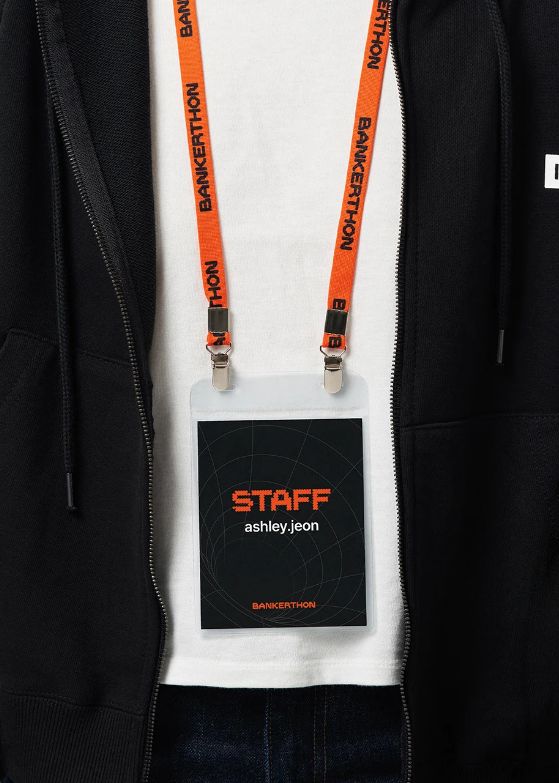 A stack of sleek, professional PVC ID cards with custom designs, one card prominently displayed featuring a corporate logo and a blurred employee photo. The cards are arranged on a clean, modern desk surface, subtly reflecting office lighting. The backgro
