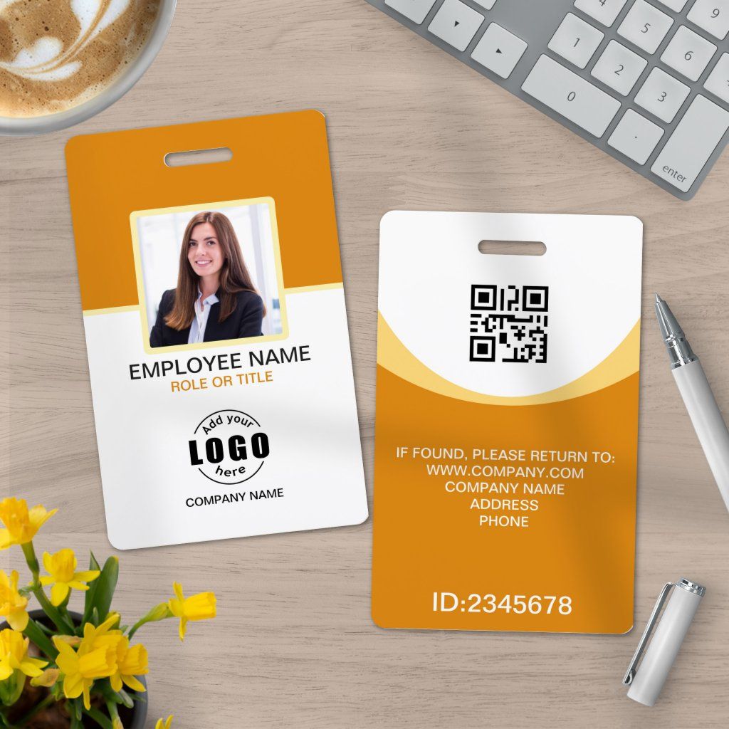 A close-up, slightly angled shot of a modern, sleek custom ID card held by a professional hand. The card prominently features a company logo in vibrant brand colors, a clear employee photo, and a professional font for the name and title. The background is